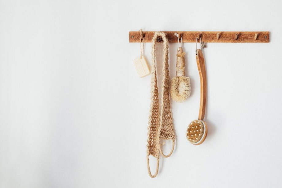 A wooden rack with some different items hanging on it